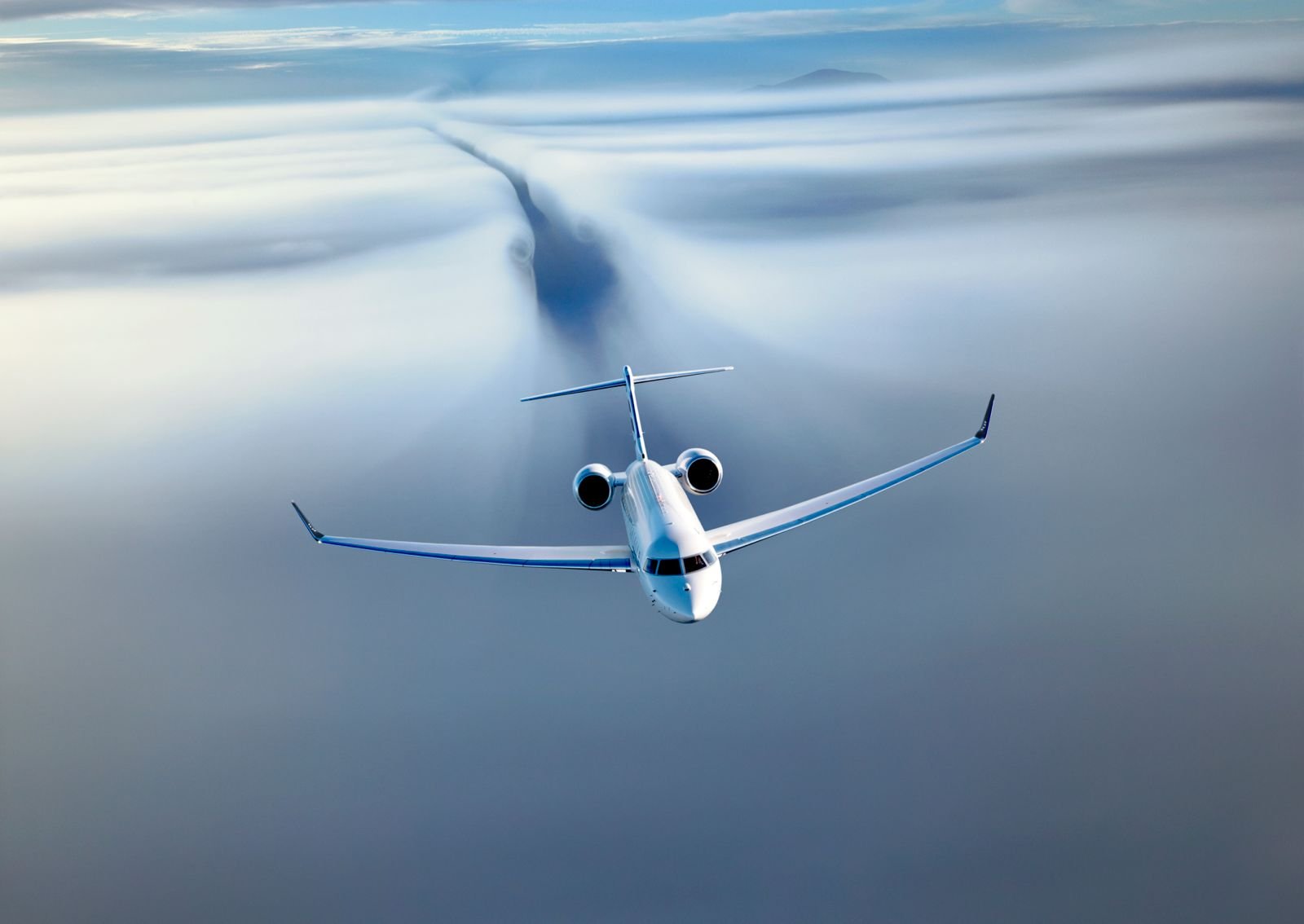 Business jet flying above a cloud layer
