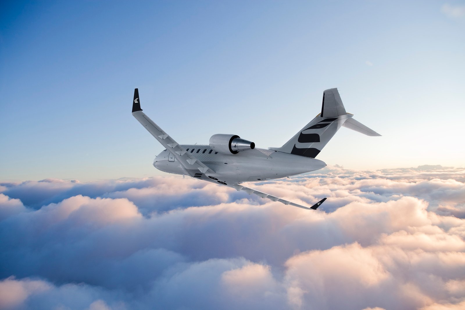 Bombardier Challenger 650 flying through pink and blue clouds